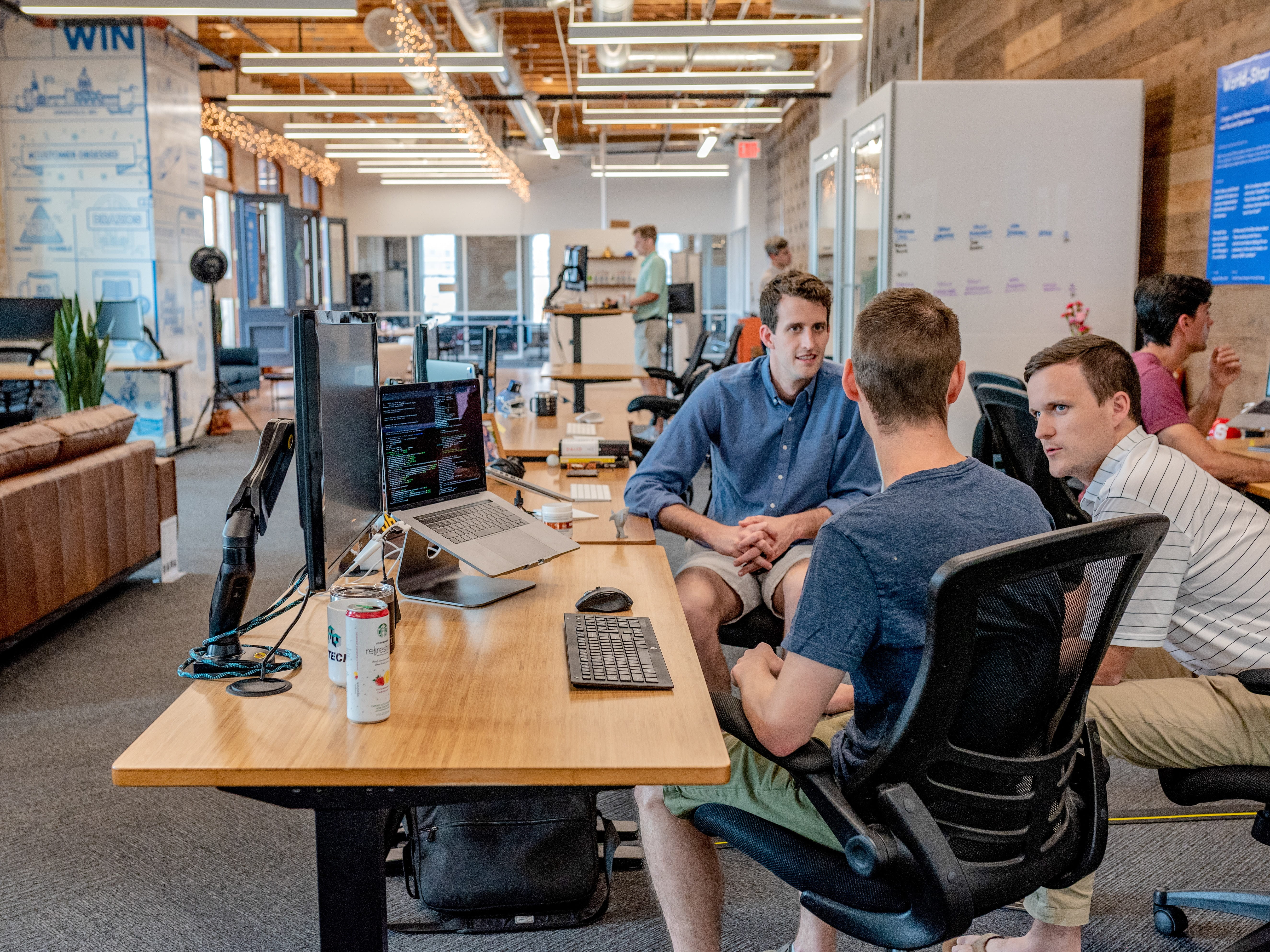 The RyanTech team gathers around for a team meeting at their office.